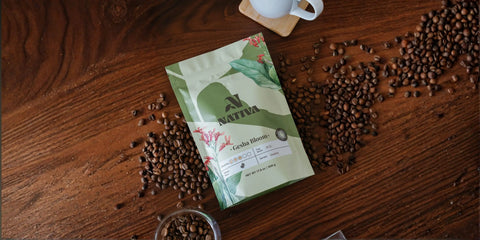 Nativa coffee package with Gesha Bloom Coffee on a wooden surface with coffee beans