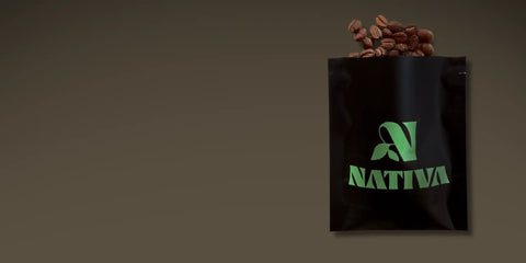 sample coffee bag with green logo labeled 'Nativa' filled with coffee beans on a dark background
