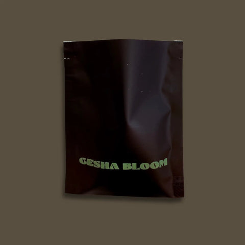 Sample black bag with 'GESHA BLOOM' text on a dark background