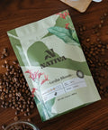 Nativa coffee package with coffee beans on a wooden surface