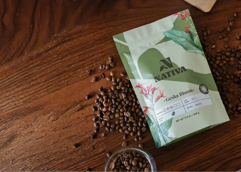 Nativa coffee package with Gesha Bloom Coffee on a wooden surface with coffee beans