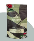 Nativa Mellow Morning coffee package with coffee beans and leaves on a light gray background