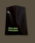 Sample black coffee bag with 'Mellow Morning' text on a dark background