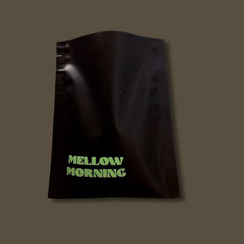 Sample black coffee bag with 'Mellow Morning' text on a dark background
