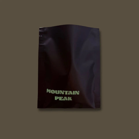 Sample dark package with 'Mountain Peak' text on a beige background