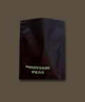 Sample dark package with 'Mountain Peak' text on a beige background