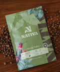 Nativa coffee package with coffee beans on a wooden surface