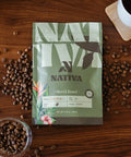 Nativa coffee package on a wooden surface with coffee beans