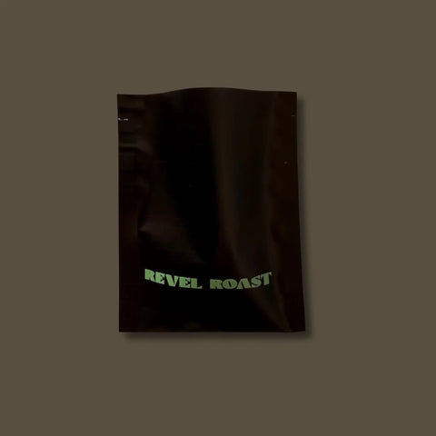 Sample black bag with 'REVEL ROAST' text on a dark background