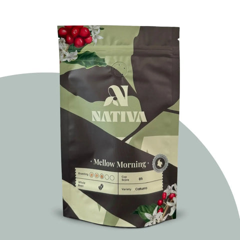 Nativa Mellow Morning coffee package with coffee beans and leaves on a light gray background